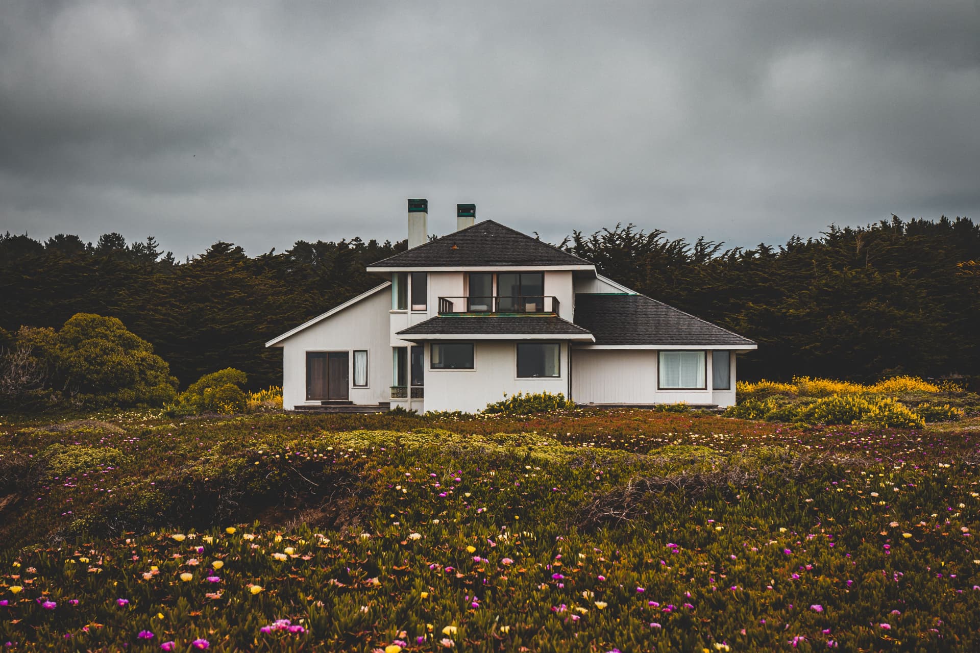 Coastal Marin home under a stormy sky, roofline and siding in sharp relief