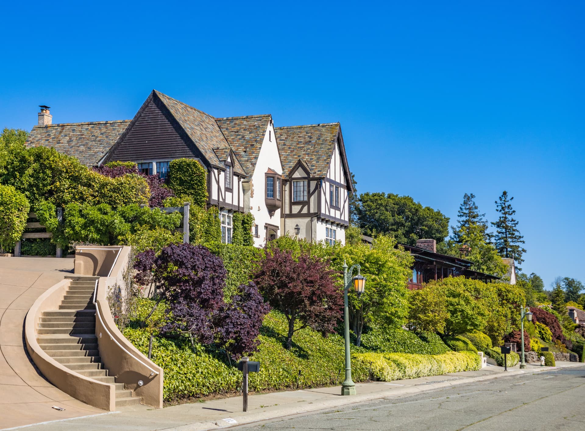 Historic hillside home surrounded by mature landscaping in the East Bay